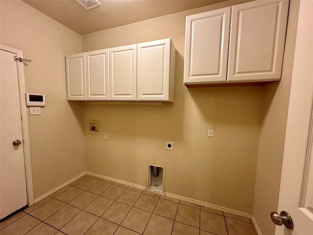 clothes washing area with light tile patterned flooring, electric dryer hookup, cabinets, and washer hookup