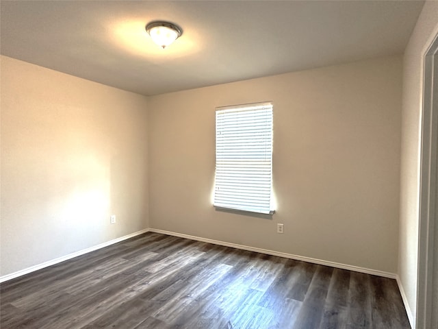 empty room featuring dark wood-type flooring