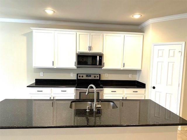 kitchen with dark stone counters, white cabinets, sink, ornamental molding, and appliances with stainless steel finishes