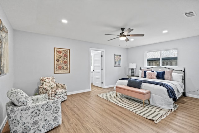 bedroom featuring connected bathroom, light wood-type flooring, and ceiling fan