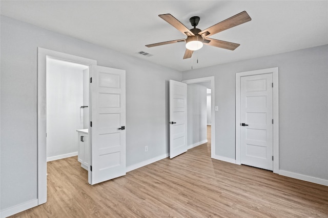 unfurnished bedroom with ceiling fan and light wood-type flooring