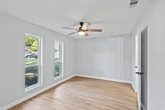 spare room with ceiling fan and light wood-type flooring