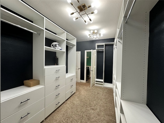 walk in closet with light carpet