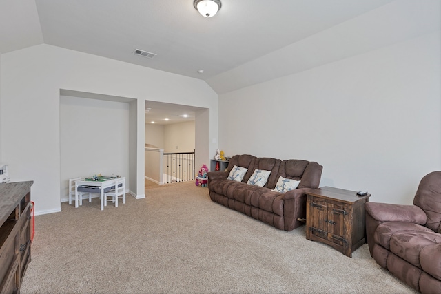 carpeted living room with vaulted ceiling