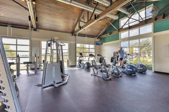 gym featuring high vaulted ceiling and wooden ceiling