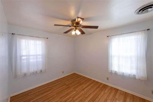 spare room featuring light hardwood / wood-style floors and ceiling fan