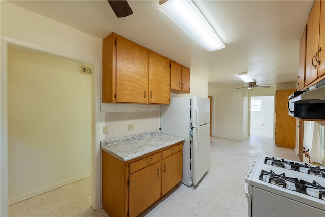 kitchen with white appliances, ceiling fan, and ventilation hood