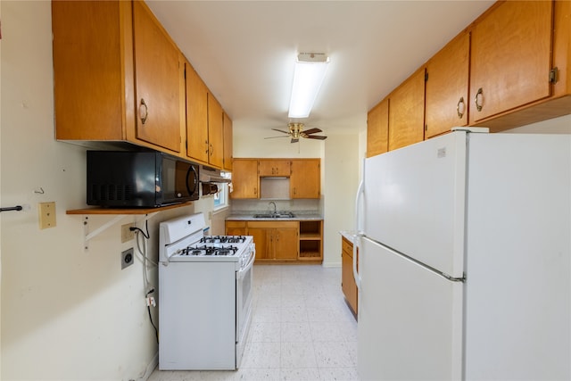 kitchen with sink, white appliances, and ceiling fan