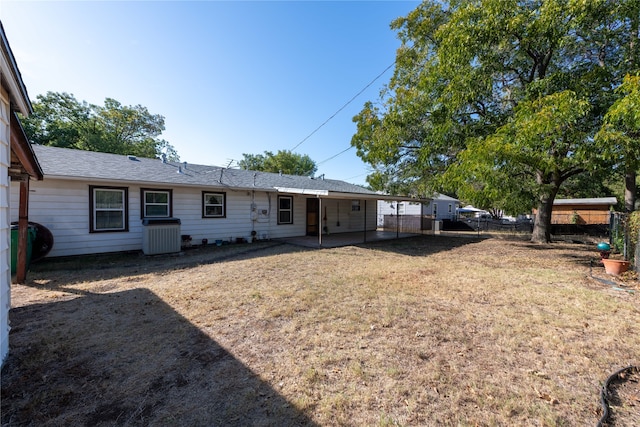 rear view of house featuring a yard and a patio area