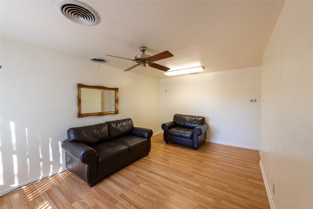 living room featuring ceiling fan and light hardwood / wood-style flooring