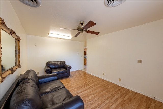 living room with light hardwood / wood-style flooring and ceiling fan