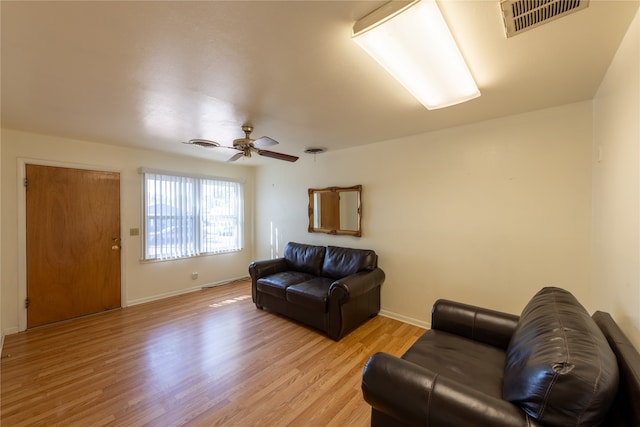 living room featuring light wood-type flooring and ceiling fan