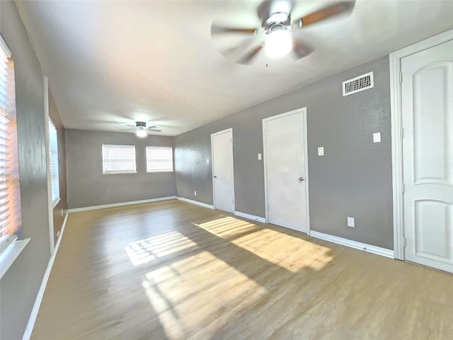 empty room featuring ceiling fan and hardwood / wood-style flooring