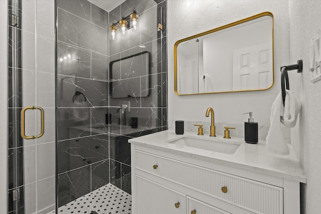 bathroom with vanity and a shower with shower door