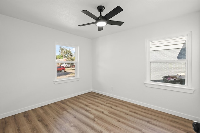 empty room featuring light hardwood / wood-style flooring and ceiling fan