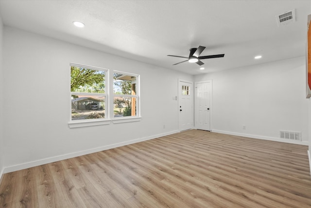 empty room featuring light wood-type flooring and ceiling fan