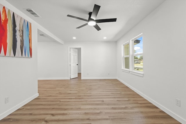 spare room featuring ceiling fan and light hardwood / wood-style flooring