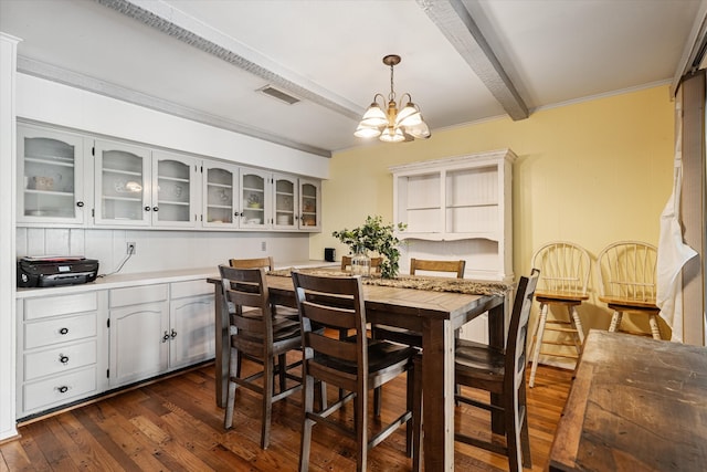 dining room featuring an inviting chandelier, ornamental molding, beam ceiling, and dark hardwood / wood-style flooring