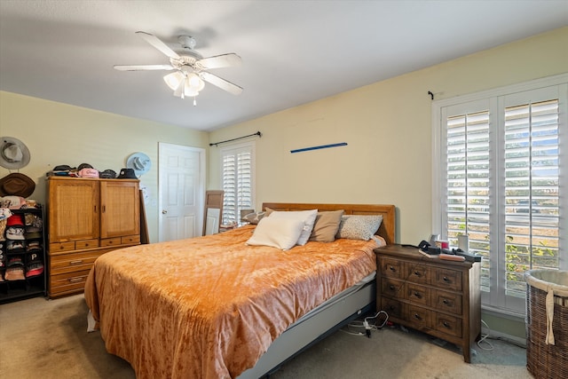 bedroom featuring light carpet, multiple windows, and ceiling fan