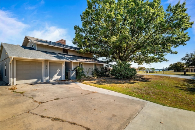 view of front of house with a front lawn and a garage