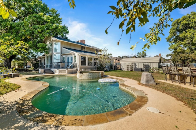 view of pool featuring a patio and an in ground hot tub