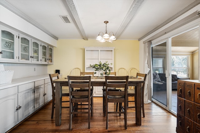 dining room featuring dark wood-type flooring, ornamental molding, beamed ceiling, and a chandelier