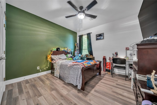 bedroom featuring light wood-type flooring and ceiling fan