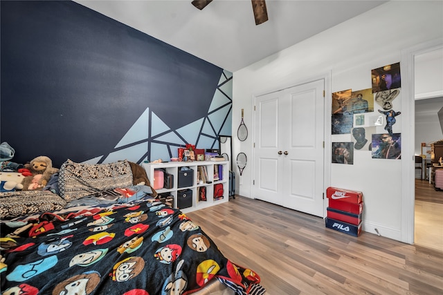 bedroom featuring wood-type flooring, a closet, and ceiling fan