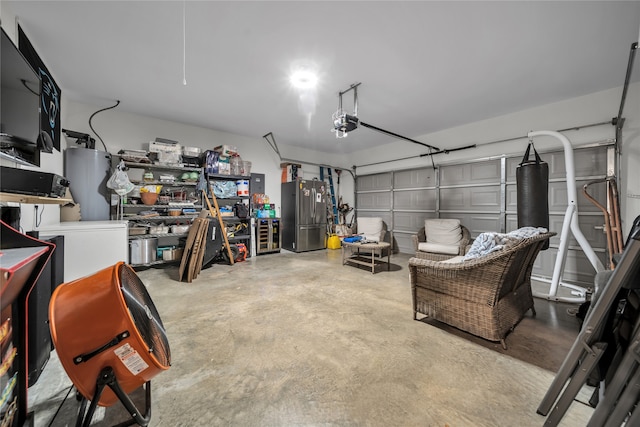 garage featuring a garage door opener and stainless steel refrigerator