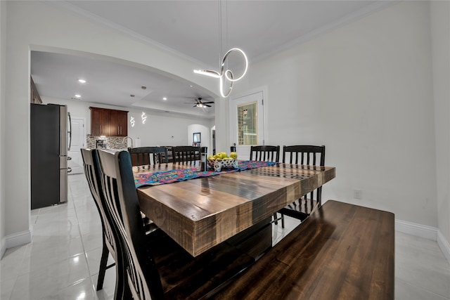 dining room featuring ceiling fan, crown molding, and light tile patterned floors