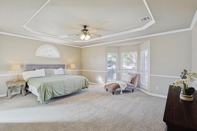 carpeted bedroom featuring ornamental molding, a raised ceiling, and ceiling fan