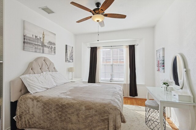 bedroom with light hardwood / wood-style flooring and ceiling fan