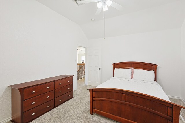 bedroom with ceiling fan, lofted ceiling, and light colored carpet