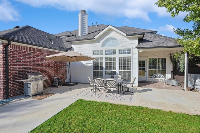 back of property with a patio and a lawn