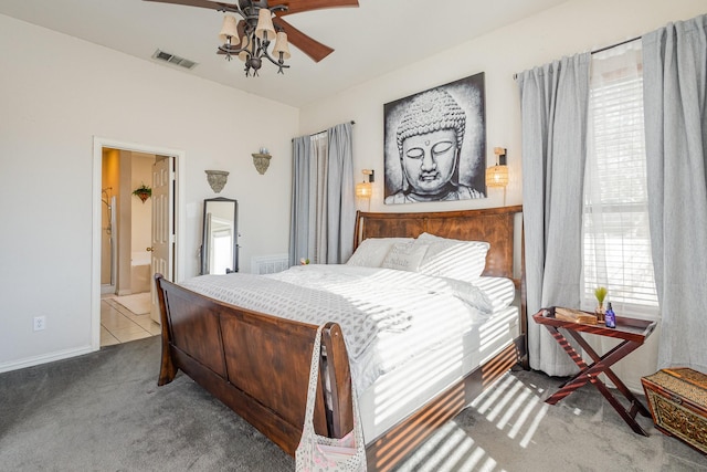 carpeted bedroom featuring connected bathroom and ceiling fan