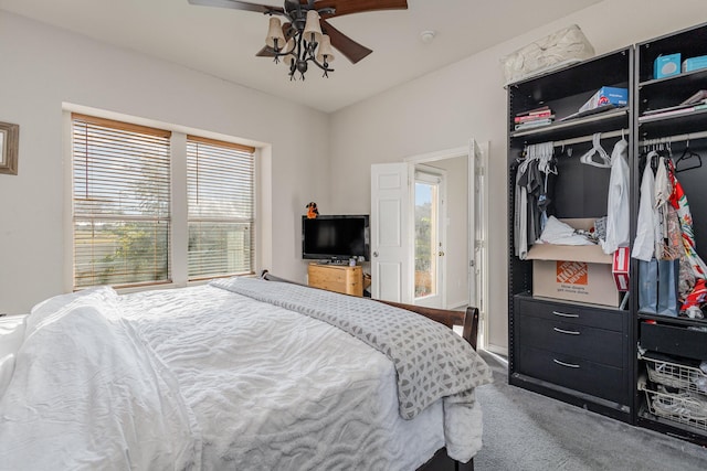 carpeted bedroom featuring ceiling fan and a closet