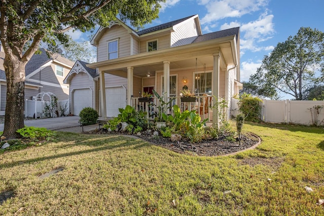 view of front of property featuring a garage, a front lawn, and covered porch