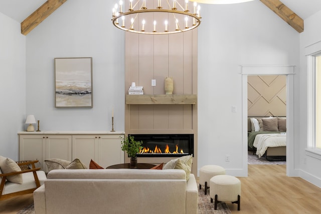 living room featuring beam ceiling, light hardwood / wood-style flooring, and high vaulted ceiling