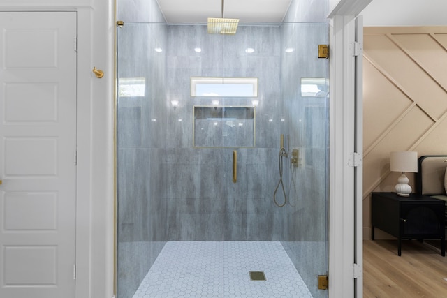 bathroom featuring walk in shower and wood-type flooring