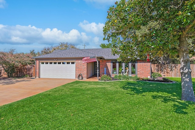 view of front of house featuring a garage and a front lawn