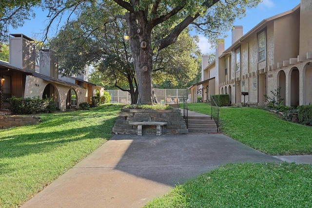 view of home's community with a yard and a patio