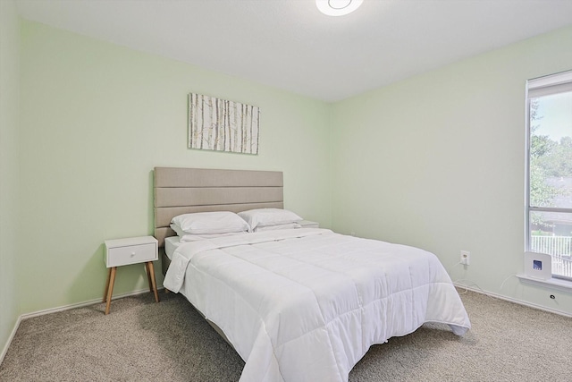 carpeted bedroom featuring multiple windows