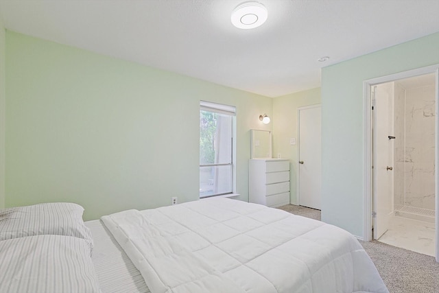 carpeted bedroom featuring ensuite bath