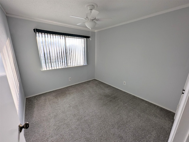 carpeted spare room featuring ceiling fan, ornamental molding, and a textured ceiling