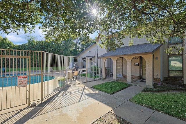 exterior space featuring a pool and a patio