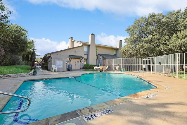 view of swimming pool with a patio