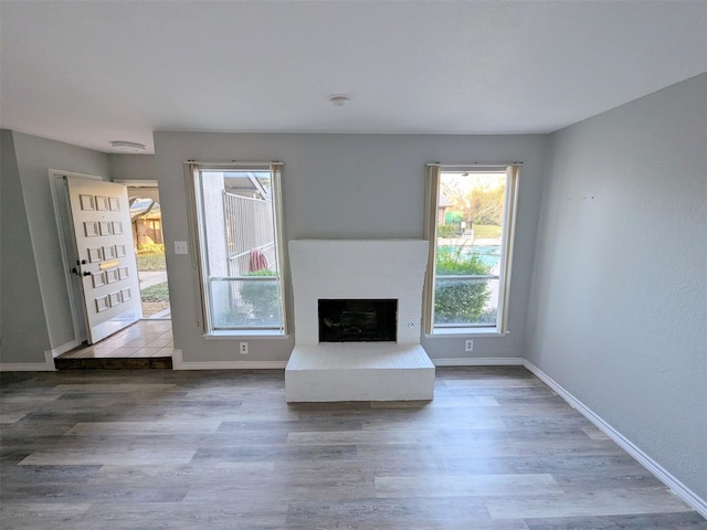 unfurnished living room featuring a fireplace and hardwood / wood-style floors