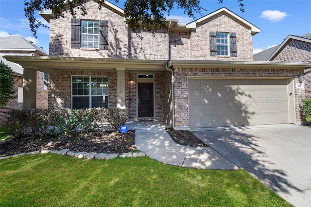 view of front of home with a front yard and a garage