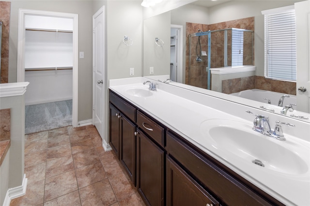 bathroom with vanity, tile patterned floors, and plus walk in shower