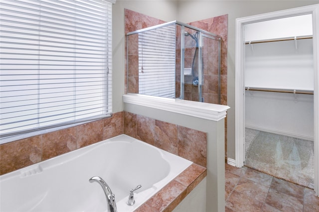 bathroom featuring tile patterned floors, a wealth of natural light, and shower with separate bathtub